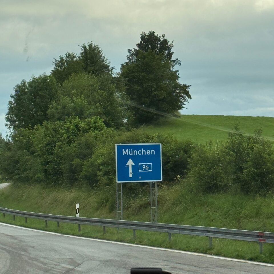Autobahnschild Richtung München an grüner Böschung