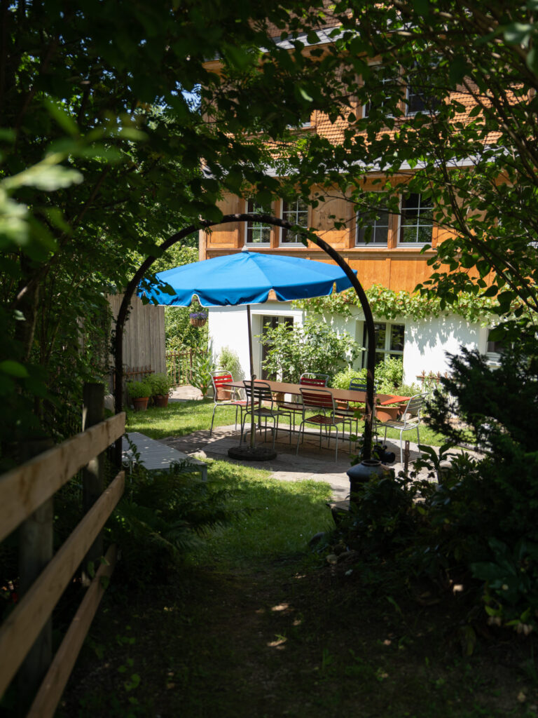 Garten mit Tisch und Sonnenschirm