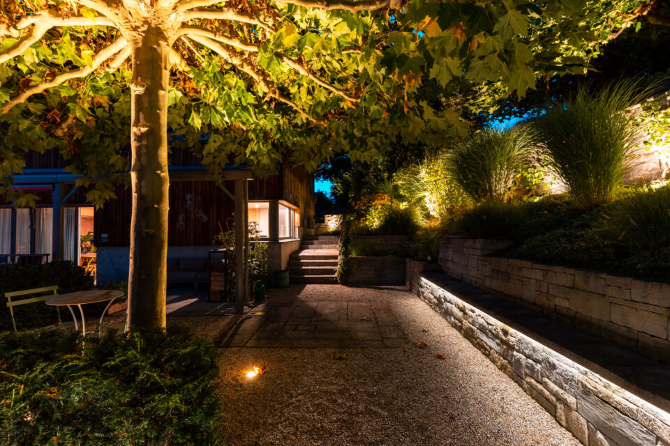 Beleuchteter Gartenweg und Terrasse bei Nacht